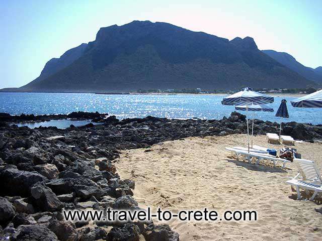 AKROTIRI STAVROS - The rocks at the end of the beach. At the background the hill where scenes of Alexis Zorbas were filmed.