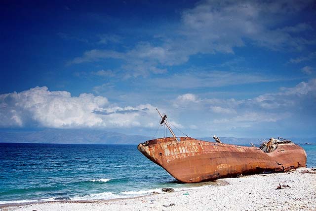 Shipwrek - A shipwreck on a beach by Konstantinos Roussos