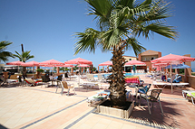 The view of the swimming pool and the beach of Maleme in front of Castro beach Hotel