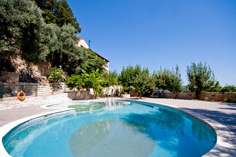 The outside view of Kastellos Village  House surrounded by trees CLICK TO ENLARGE